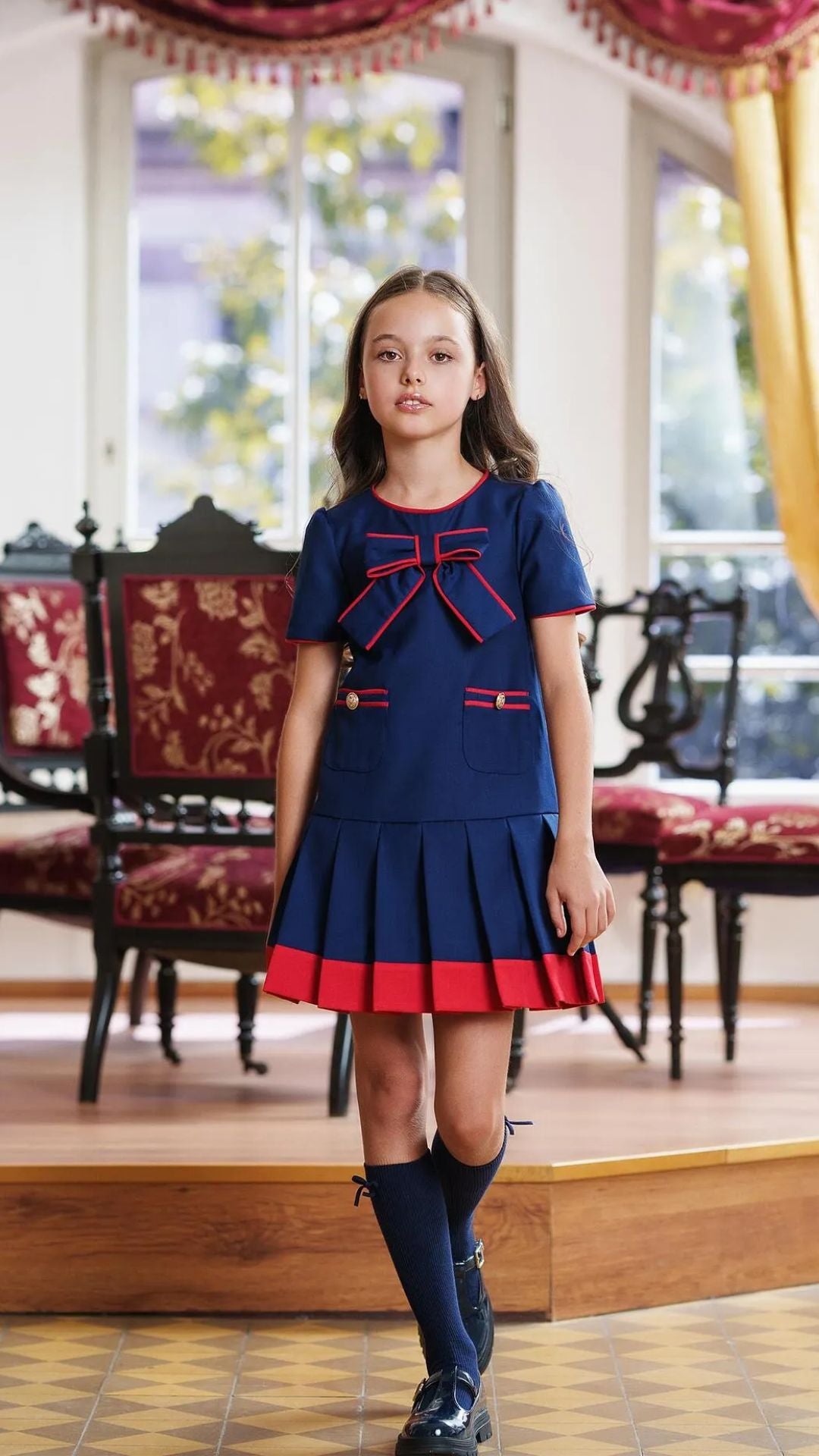 Girls’ Navy Blue Pleated Dress with Red Trim & Bow